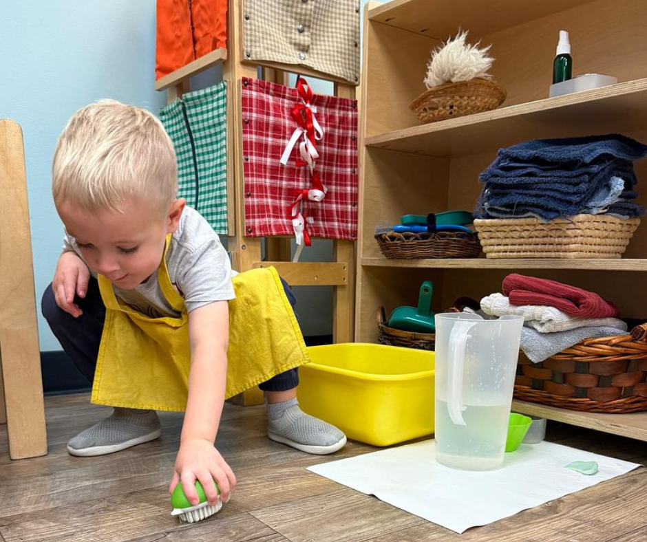 child cleaning the floor in a montessori school in fort wayne, in