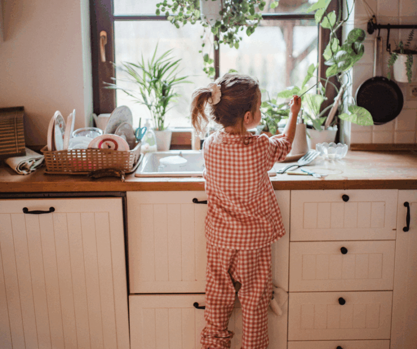 child doing dishes at home