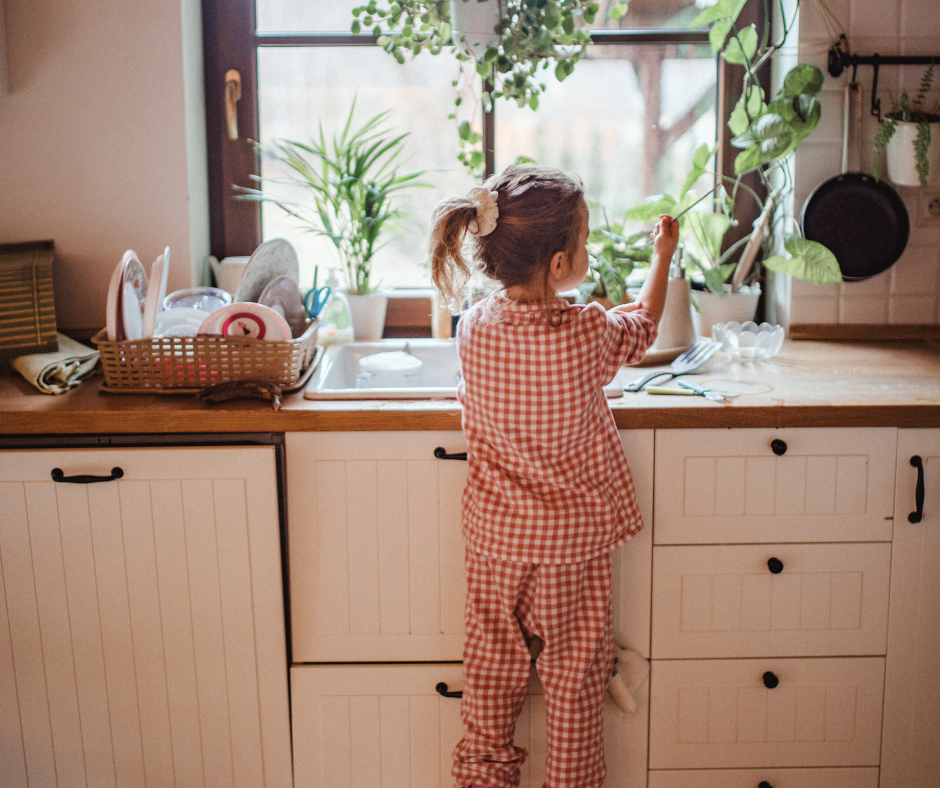 child doing dishes at home