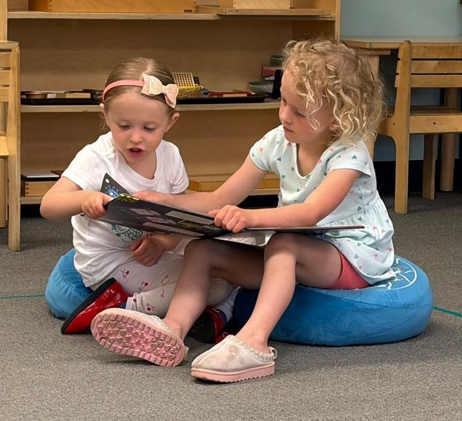 children read together in a Montessori preschool classroom