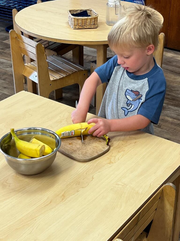 student preparing food in a Montessori classroom